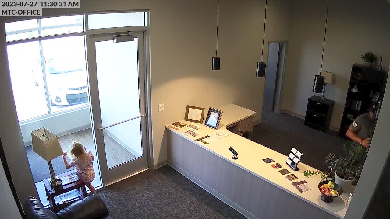 Video thumbnail showing: A young girl runs straight into the glass door as she's leaving an office. Security footage.