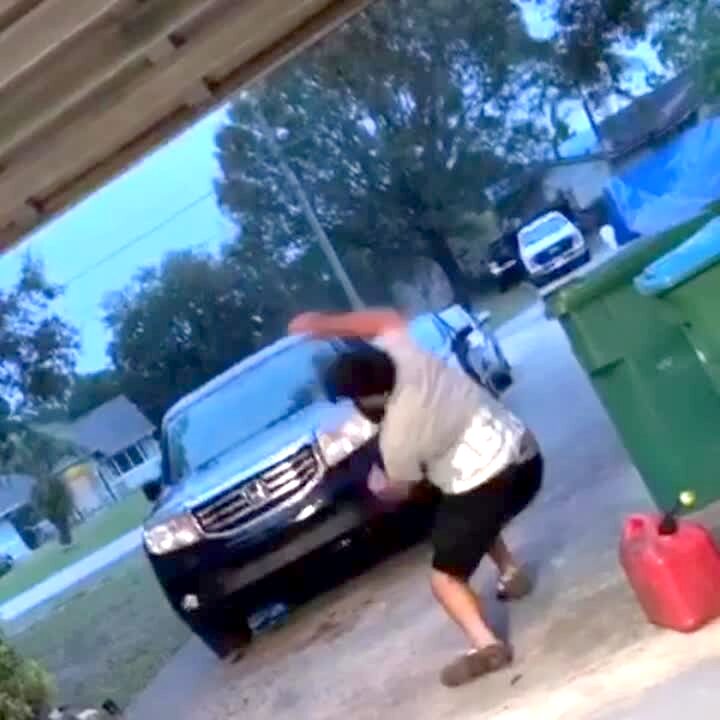 Video thumbnail showing: A man slides on the slick floor of a garage then slips and topples over into a garbage bin.
