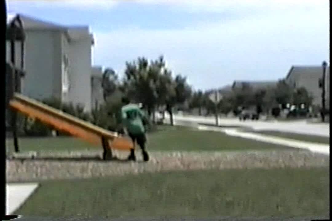 Video thumbnail showing: Boys throw a basketball from Jungle Gym trying to make a basket.  They miss a dozen times and finally make it.