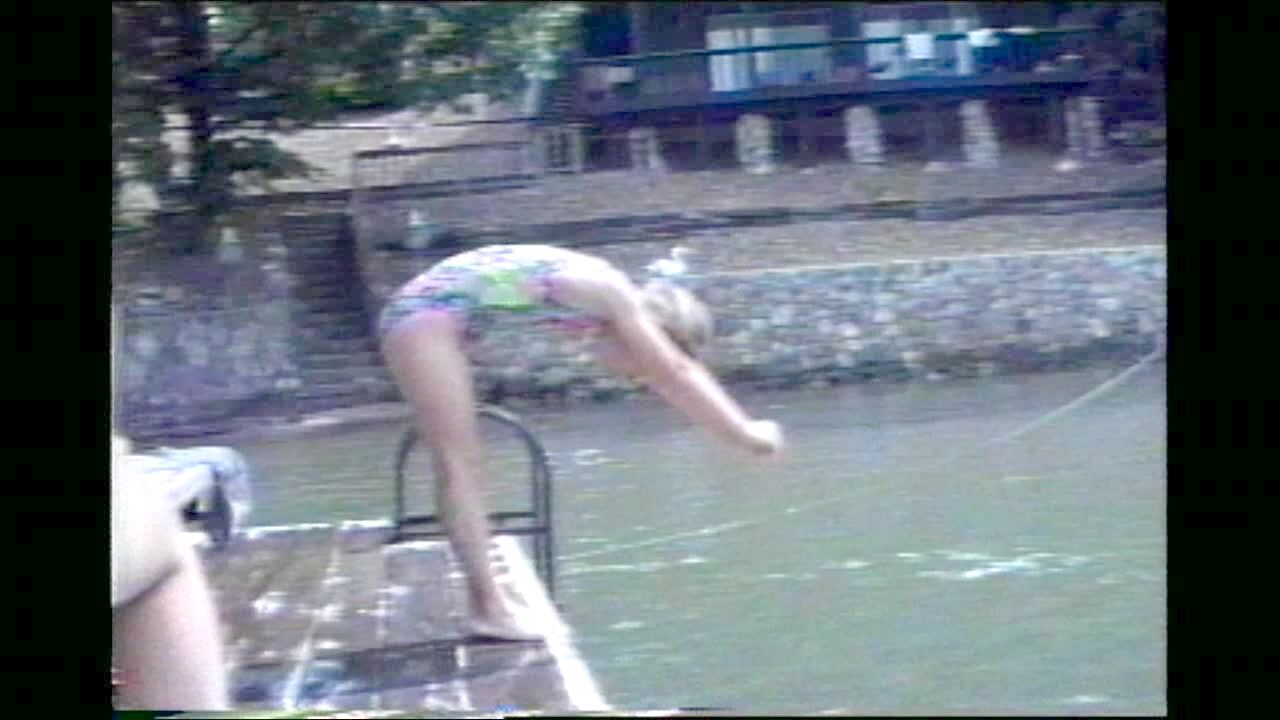 Video thumbnail showing: Belly Flop Dive. Girl dives off dock, does belly flop into water.