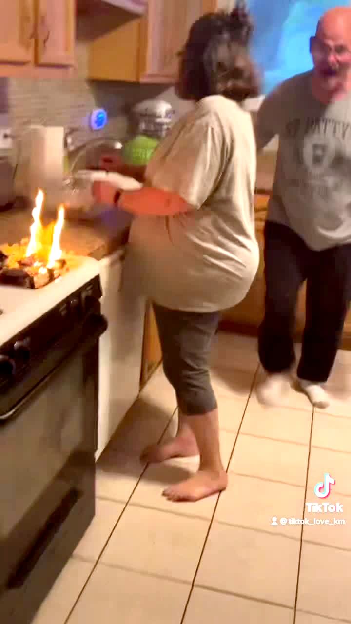 Video thumbnail showing: A family in the kitchen makes popcorn on the stove but it catches on fire. They all scream as a man struggles to find water. The man screams the loudest.